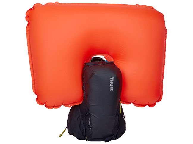 One of the snowboard backpacks with a white background and an inflated airbag.