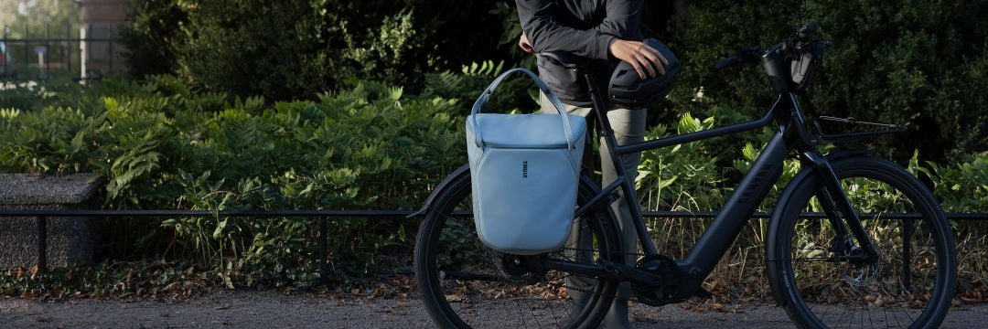 A Thule pannier mounted on an e-bike using the InLock system by Thule, designed for fast, secure attachment and everyday bike commuting.