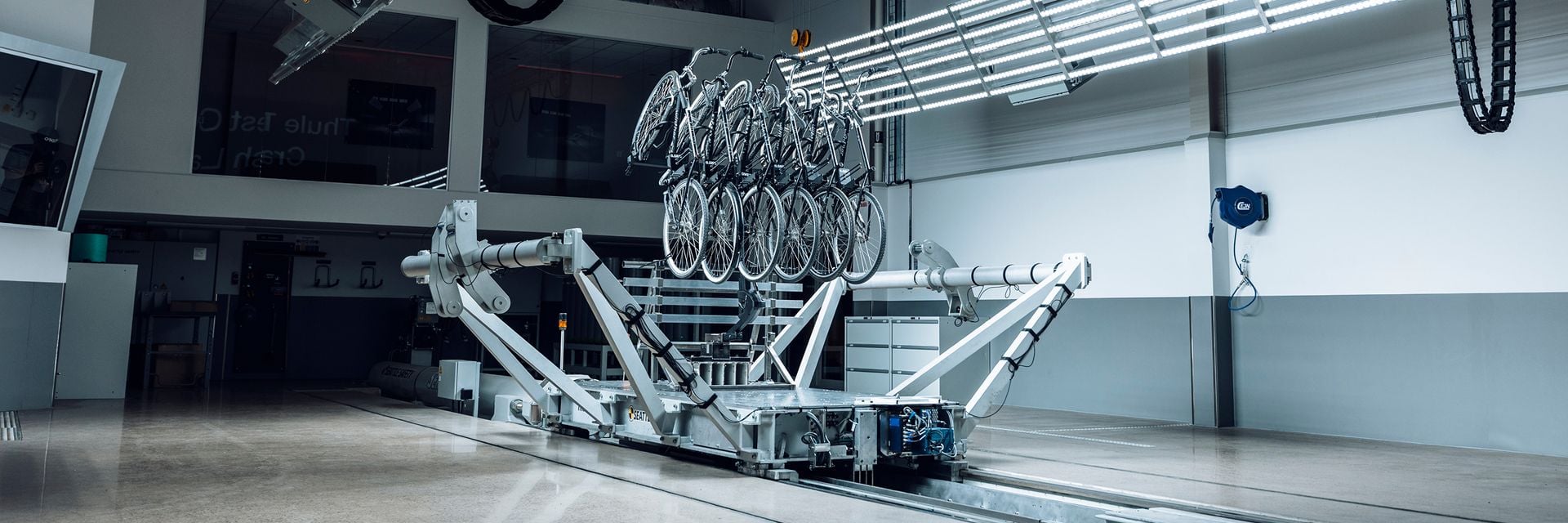 6 bikes are mounted on a Thule bike rack while undergoing testing on a sled at the Thule Test Center. 
