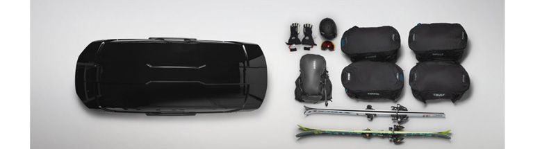 A flatlay of the Thule Motion XT XL roof-box-featuring all the ski gear you can fit inside.