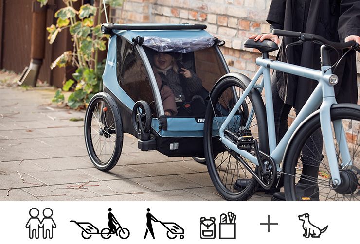 A close up of a child inside a Thule Courier child bike trailer