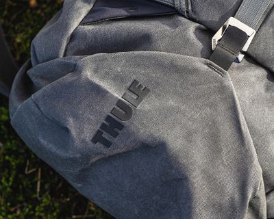 A zoom in photo of a gray Thule All Trail XT backpack.