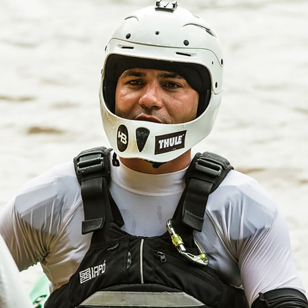 A close up image of Pedro Oliva wearing a white full-face helmet.
