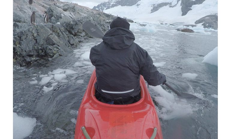 Pedro Oliva paddles his kayak through the icy waters of Antarctica.