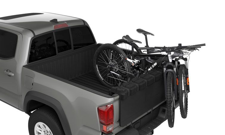 A Thule GateMate PRO truck bed bike rack carrying two bikes.