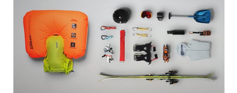 A flat lay of the Thule Upslope ski backpack with all the items you can back inside.