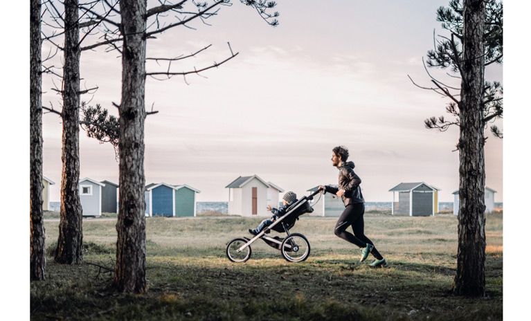 What are the benefits of running with a jogging stroller?