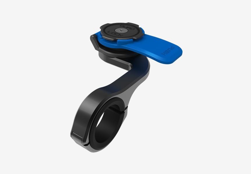 Close up of a QuadLock phone mount against a gray background. 