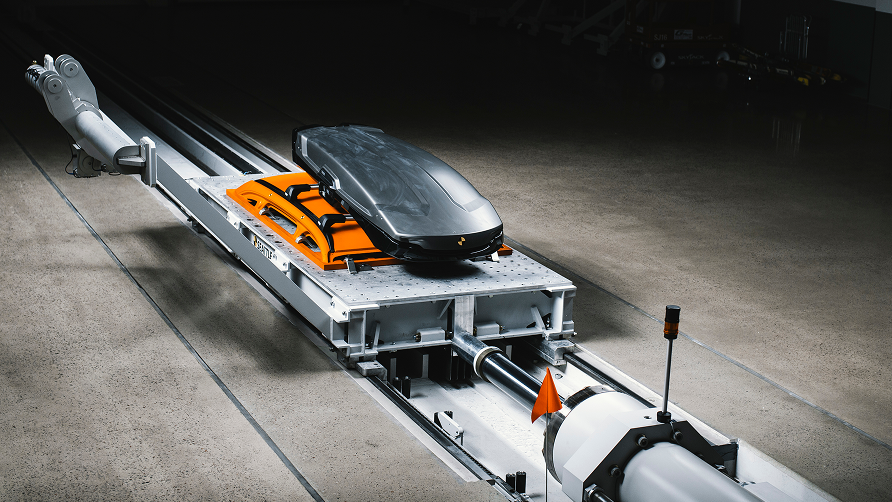 Thule roof box crash test on sled with car frame at Thule Test Center