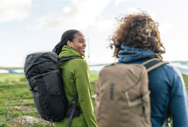 Two people go for a hike with Thule hikinh backpacks.