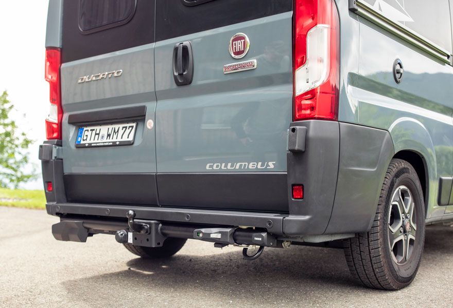 A close-up of a vehicle with the Thule Veloswing towbar attached to the bumper.
