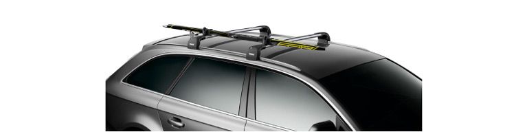 A close-up of the Thule SkiClick ski rack on a car with a white background.