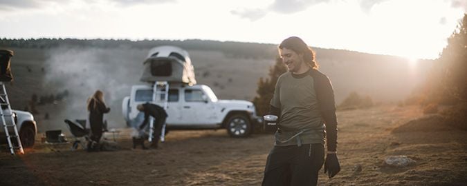 &#x4E00;&#x540D;&#x7537;&#x5B50;&#x5728;&#x80CC;&#x666F;&#x4E2D;&#x7AEF;&#x8457;&#x71B1;&#x98F2;&#x884C;&#x8D70;&#xFF0C;&#x4EBA;&#x5011;&#x5728; Thule Approach &#x8ECA;&#x5E33;&#x56DB;&#x5468;&#x7D2E;&#x71DF;