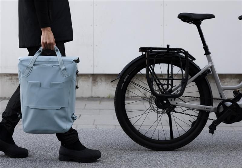 Person walking with a bag attached using the InLock pannier system by Thule.
