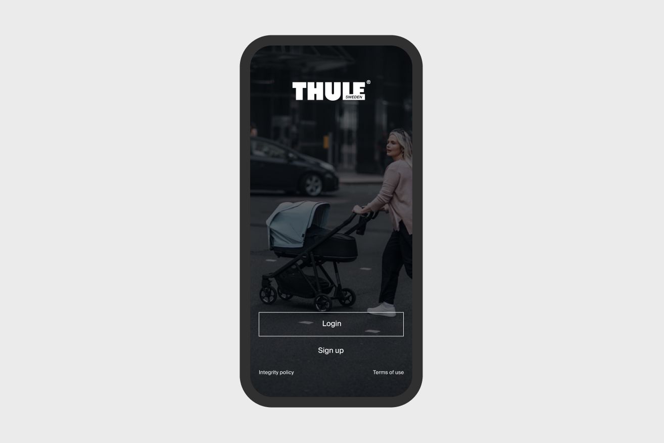 A picture of the Thule App on the screen of a phone with a woman strolling in the background.
