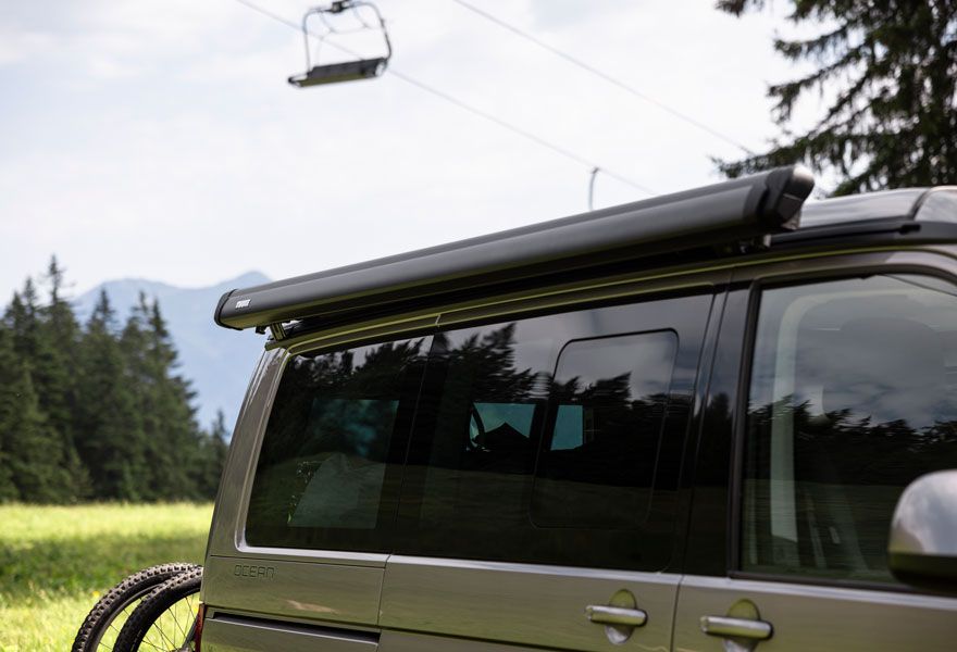 A van has the Thule Sidehill compact awning installed and it does not raise the height of the roof.