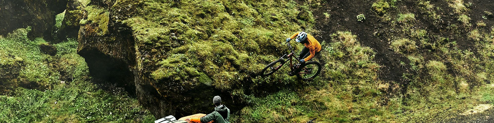 Eliot Jackson riding on a mountain bike through a field.